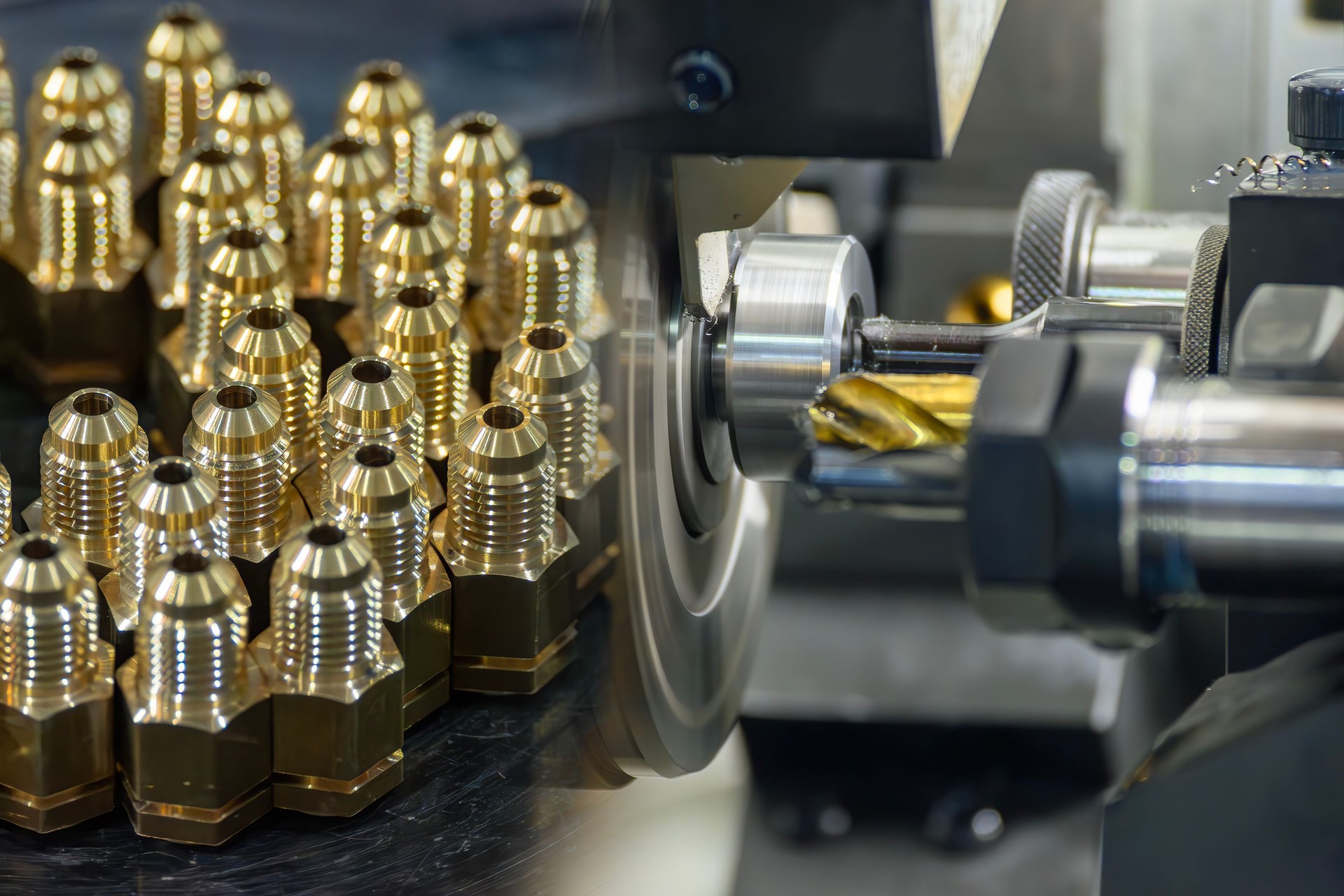 Abstract scene the multi tasking CNC lathe machine and the group of brass male fitting connector parts.