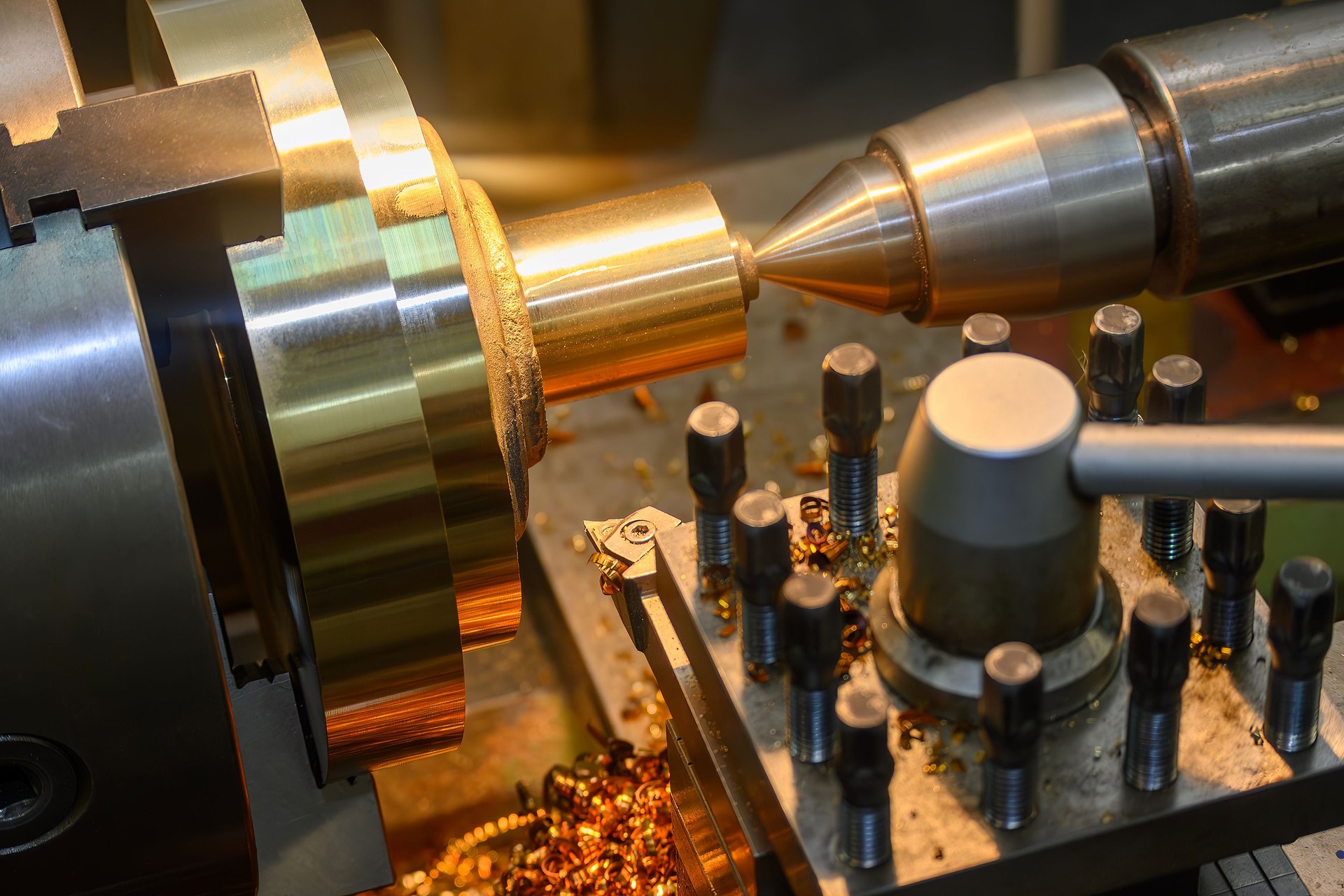 The lathe machine finish cut the brass material parts by lathe tools.