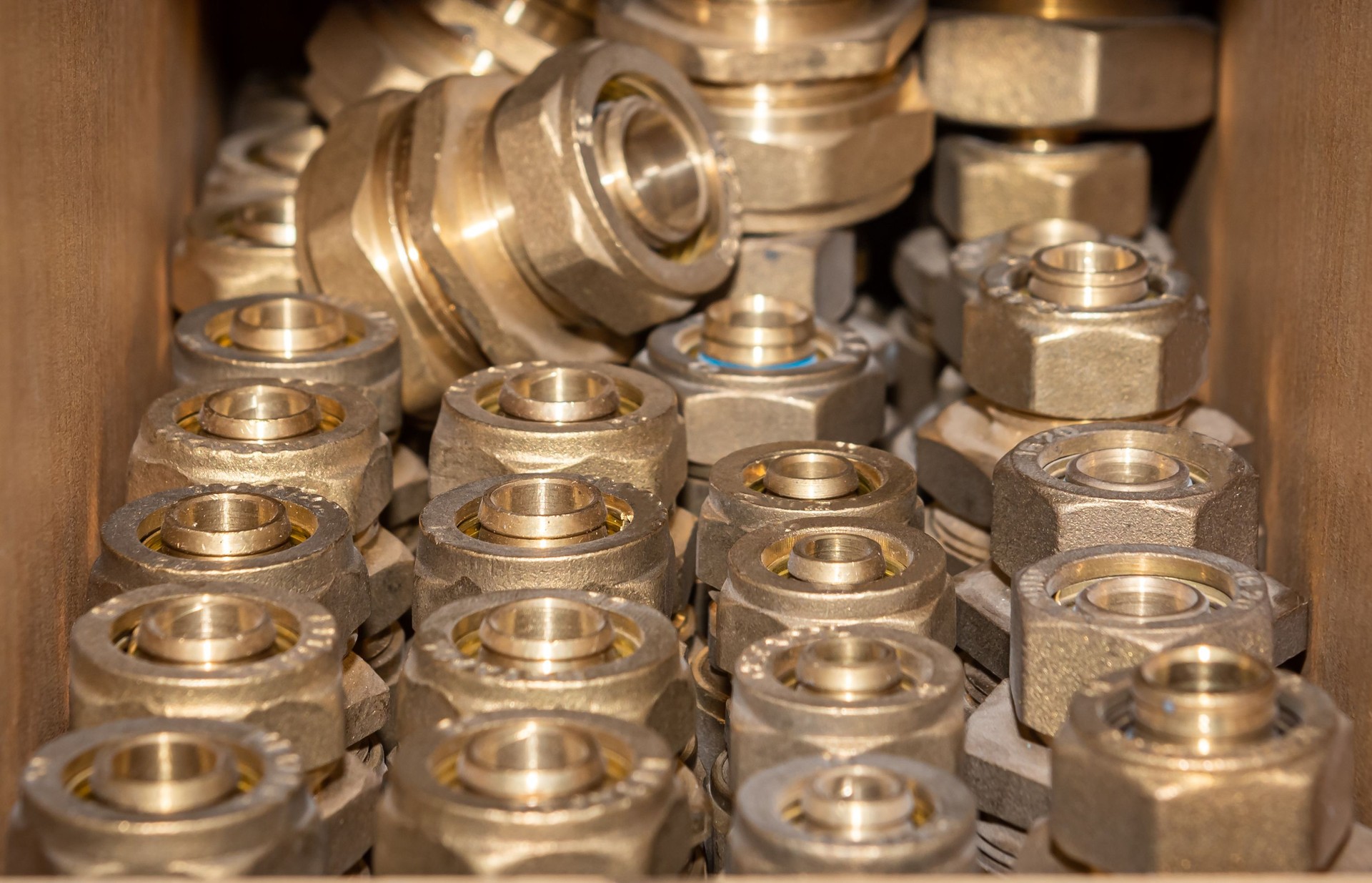 Metal plumbing pipe fittings piled up in the box in a market