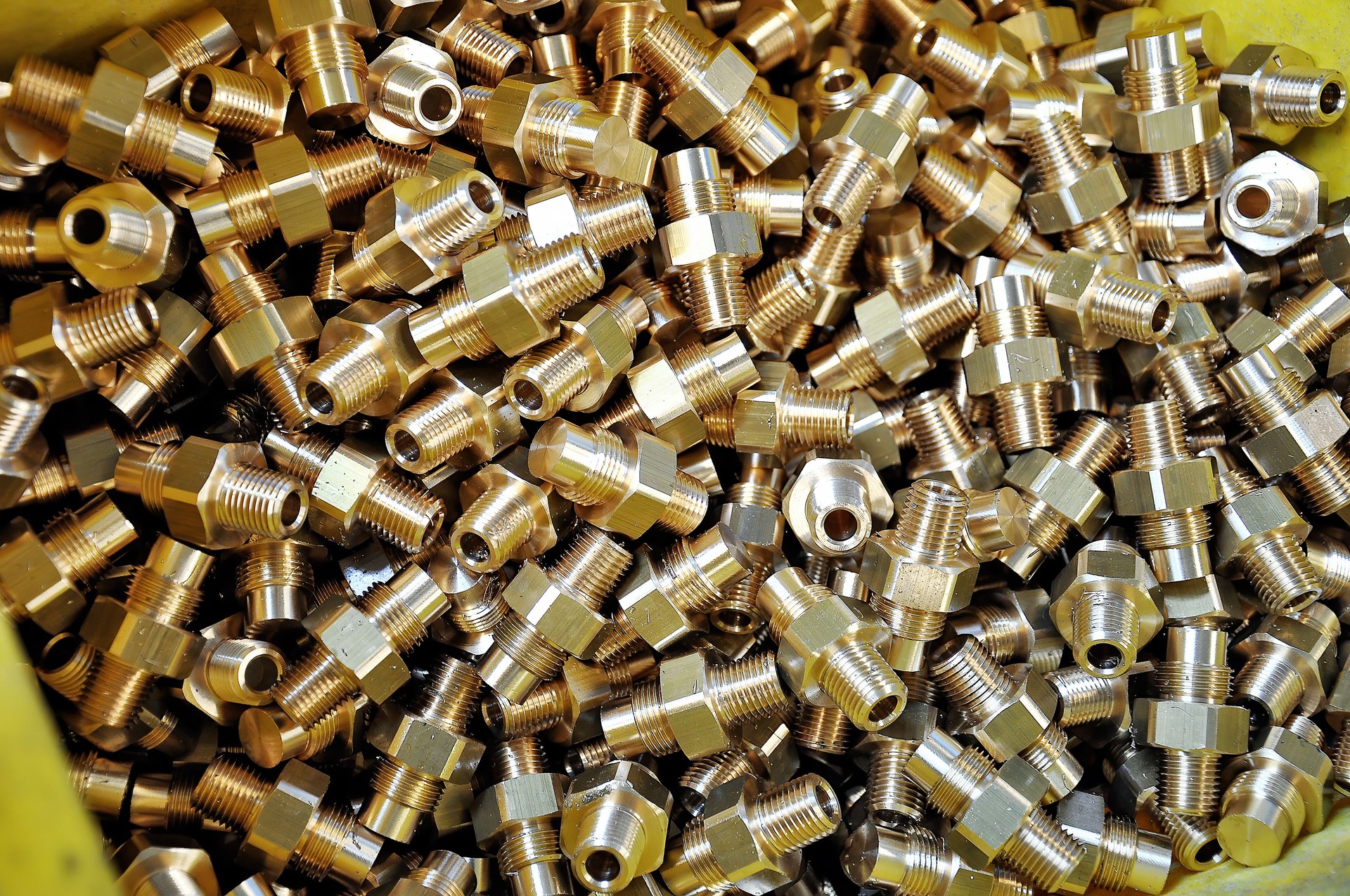 Background of Brass fittings machined with CNC lathe