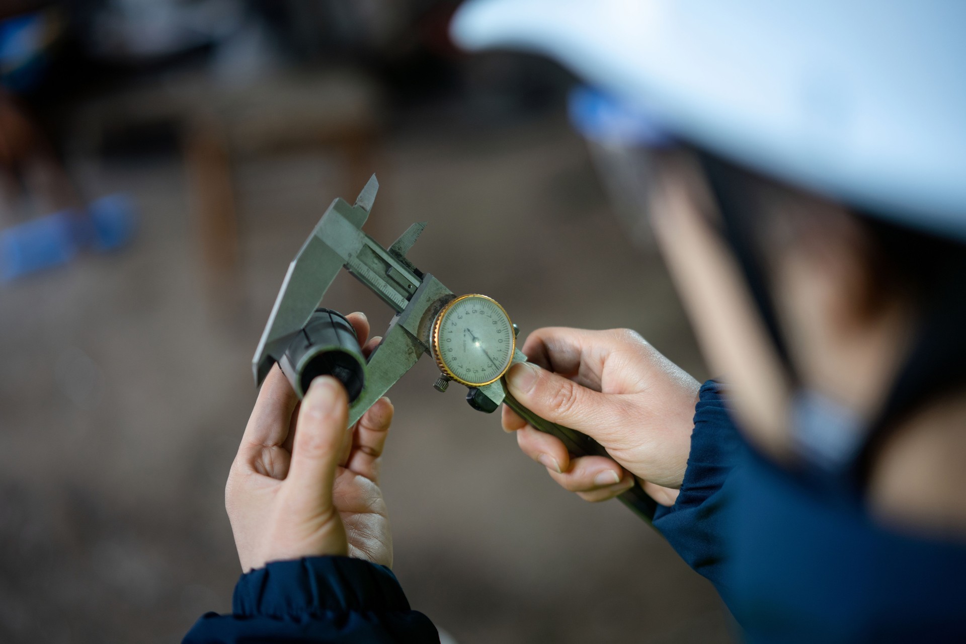 Asian female engineers are using vernier caliper  in the factory